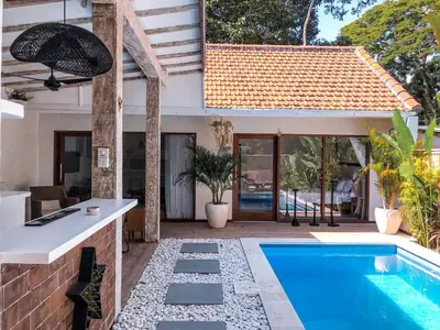 a house with a swimming pool next to a house at Villa Pastis Umalas #2, near Canggu in Canggu