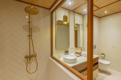 a bathroom with a sink and two mirrors and a toilet at Villa Agua Dream Canggu hideaway in Canggu