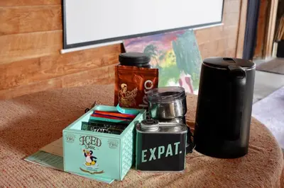 a table topped with a thermos and a box with at Spacious Family Home & Office Canggu, stay with cats in Canggu