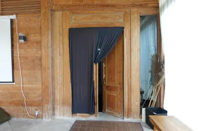 a wooden door with a black curtain on it at Spacious Family Home & Office Canggu, stay with cats in Canggu