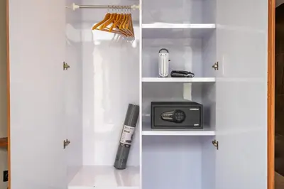 a book shelf with a toaster and a radio at Solencia Villa by Betterplace in Jimbaran