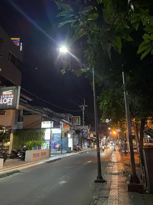 a city street at night with a street light at Cozy room Kuta - 1 minutes to the beach by Micky Studio2 in Legian