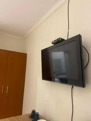 a flat screen tv hanging on a wall at Cozy room Kuta - 1 minutes to the beach by Micky Studio2 in Legian