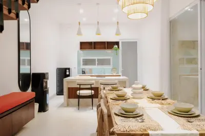 a kitchen with a long table with bowls on it at Casa De Vero Amore in Jimbaran
