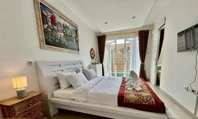 a bedroom with a large white bed and a window at Villa Velia 3BR private pool in Badung