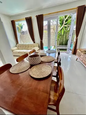 a living room with a wooden table and chairs at Villa Velia 3BR private pool in Badung