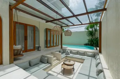 a living room with a couch and a table at Villa Viento Tropical Haven Canggu in Canggu
