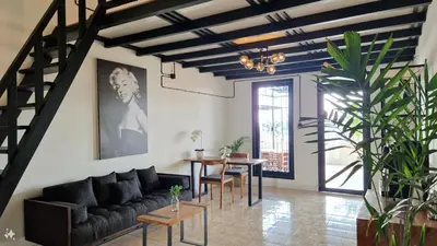 a living room with a couch and a table at Nice Place To Stay - Rooftop Apartments in Seminyak