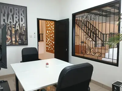 a white table and two chairs in a room at Nice Place To Stay - Rooftop Apartments in Seminyak
