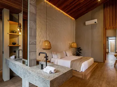 a bedroom with a bed and a sink in a room at House of Winds Complex - Lush 9BR Exotic Escape - 3x3BR Villas near Canggu in Kerobokan