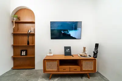 a living room with a wooden table and a shelf at Villa Sunset Waters in Legian