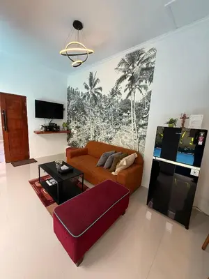a living room with a couch and a table at Erindra Villa in Pesanggaran