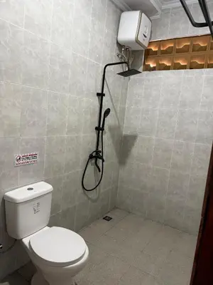 a bathroom with a toilet and a shower in it at Erindra Villa in Pesanggaran