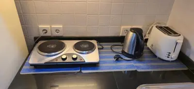 a kitchen counter with a toaster and a appliance on it at The Palmana Tropical Roofline Jayakarta Residence 40 in Badung