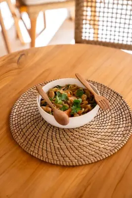 a bowl of food on a plate on a table at Antana Hotel in Canggu
