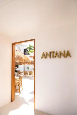a sign for anarma on the side of a building at Antana Hotel in Canggu