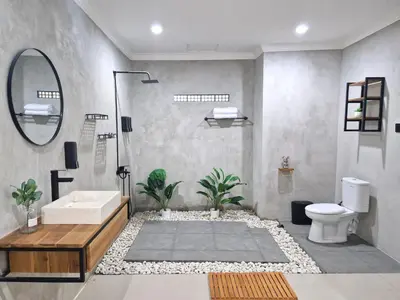 a bathroom with a sink and a toilet and a mirror at Nice Place To Stay - Cozy Living in Seminyak
