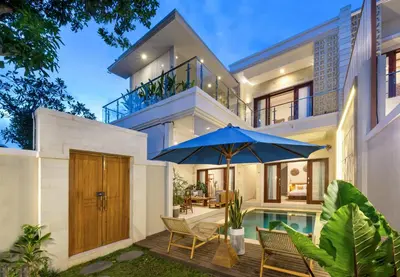 an exterior view of a house with an umbrella at Villa Lavinia - Private Pool Villa - Seminyak Kuta - Double Six Beach in Seminyak