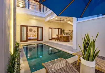 a swimming pool in a house with a blue umbrella at Villa Lavinia - Private Pool Villa - Seminyak Kuta - Double Six Beach in Seminyak
