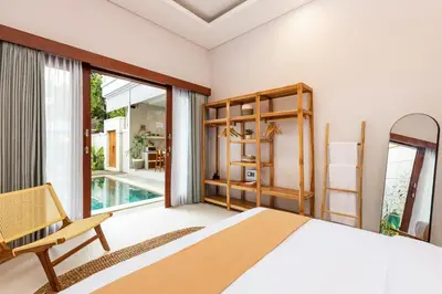 a bedroom with a large bed and a balcony at Villa Lavinia - Private Pool Villa - Seminyak Kuta - Double Six Beach in Seminyak
