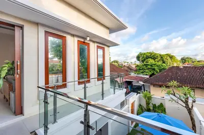 an empty balcony of a house with windows at Villa Lavinia - Private Pool Villa - Seminyak Kuta - Double Six Beach in Seminyak