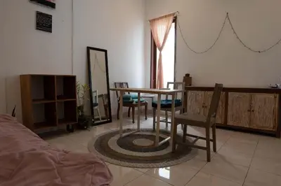 a room with a table and chairs and a mirror at Mirri House Kerobokan in Seminyak