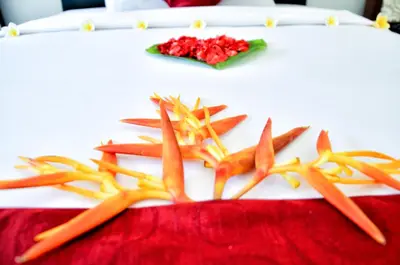 a group of carrots on a table with flowers at Palm Garden Bali in Nusa Dua