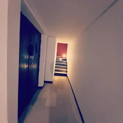 a hallway with a staircase in a white room at PalmA Private Villa - A Leafy Place in Mumbul Hill in Nusa Dua
