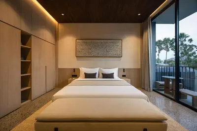 a bedroom with a large bed and a large window at Marvee Suites Bali in Canggu
