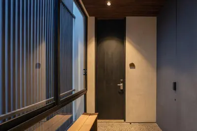 a hallway with a door and a window at Marvee Suites Bali in Canggu