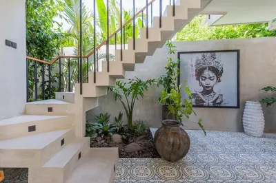 a staircase with a painting of a woman at Villa Jazz 3BR 10m Pool seminyak in Seminyak