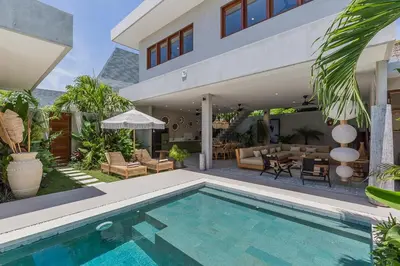 a house with a swimming pool in front of a house at Villa Jazz 3BR 10m Pool seminyak in Seminyak