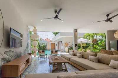 a living room with a couch and a table at Villa Jazz 3BR 10m Pool seminyak in Seminyak