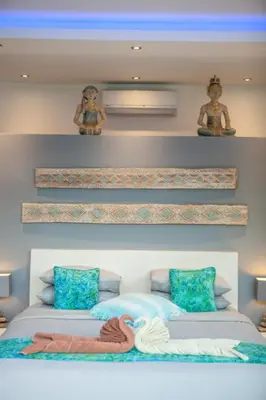 a bedroom with two beds with towels on them at Bali paradise Rosa in Seminyak