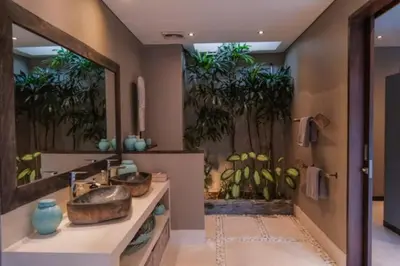 a bathroom with two sinks and a large mirror at Bali paradise Rosa in Seminyak