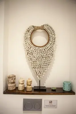 a shelf with a heart shaped mirror on a wall at Bali paradise Rosa in Seminyak