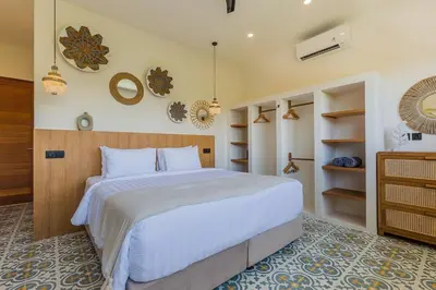 a bedroom with a large white bed and shelves at Villa Pop Cozy 2BR Villa & Pool Seminyak in Seminyak