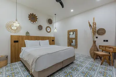 a bedroom with a bed and a desk and a mirror at Villa Pop Cozy 2BR Villa & Pool Seminyak in Seminyak
