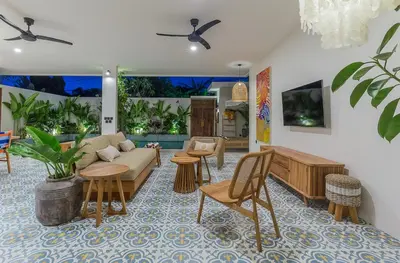 a living room with a couch and chairs at Villa Pop Cozy 2BR Villa & Pool Seminyak in Seminyak