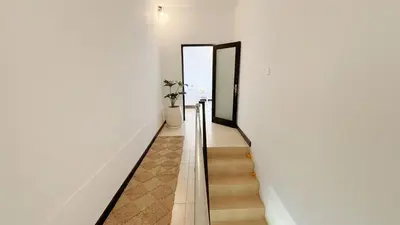 a staircase leading to the second floor of a house at Villa Mandari in Seminyak