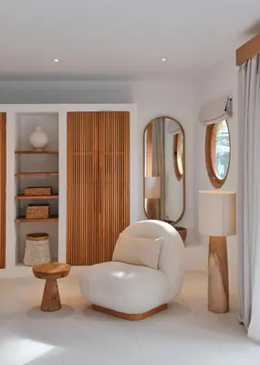 a white living room with a white chair and a mirror at Villa Bali Manis by The Bali Agent - Central Seminyak 4BR Villa with Private Pool, Perfect for Families & Groups in Seminyak