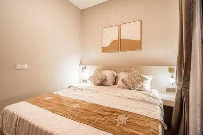 a bedroom with a large bed with two pillows at Renjana Villa-2BR Modern Tropical Villa in Seminyak with Private Pool & Rice Field View in Seminyak