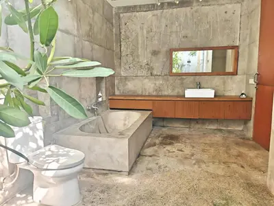 a bathroom with a tub and a toilet and a sink at Large Villa Jimbaran With Pool & WiFi by 2ndHome in Jimbaran