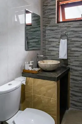a bathroom with a sink and a toilet at Villa Alase - Pool, Garden, Peace in Seminyak