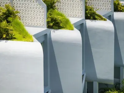 a row of white fences with plants on top at Aura Umalas - Futuristic 2BR Rooftop Villa with Green Views in Kerobokan