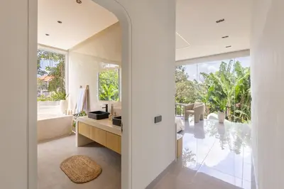 a bathroom with a tub and a sink and a mirror at Aura Umalas - Futuristic 2BR Rooftop Villa with Green Views in Kerobokan