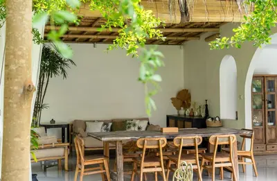 a dining room with a table and chairs at 3BR Green Oasis downtown Berawa Canggu in Canggu