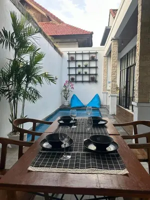 a wooden table with wine glasses on top of it at 2 Bedrooms Villa Petitenget Private Pool in Seminyak