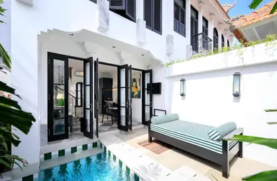a villa with a swimming pool and a house at Martini Beachside Villa 5 in Canggu