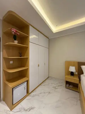 a bedroom with a bed and a tv in it at Mara inn in Nusa Dua
